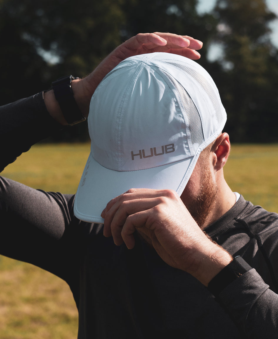 HUUB Race Cap II – mesh, flat panel, race running cap in Coral, White, or Black, ultra-lightweight and adjustable.